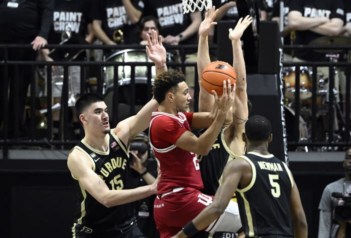 Indiana Hoosiers forward Trayce Jackson-Davis (23) jumps up with the ball against Purdue Boilermakers center Zach Edey (15) and forward Mason Gillis.